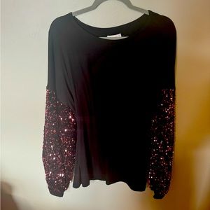 New with tags black top with pink sequin sleeves.  Soft t-shirt material.
